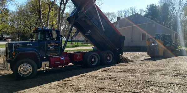 Mercurio dump truck delivering loam at residential site